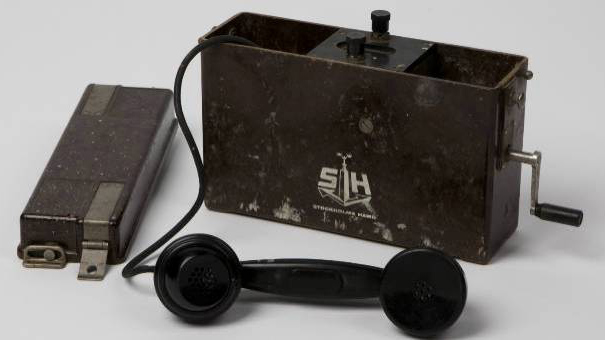 Fälttelefon, tillverkad av Ericsson. Bär Stockholms Hamnars logotyp. Cirka 1960-tal.